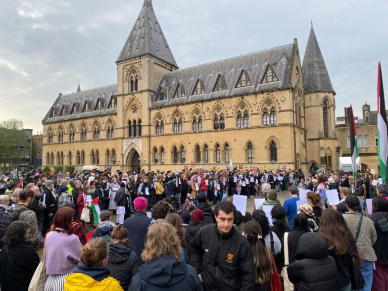 A crowd of protestors stand outside the Natural History Museum in Oxford in support of Palestine