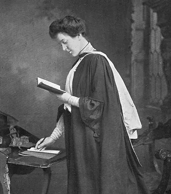 A black and white picture of a women wearing an academic gown and reading a book