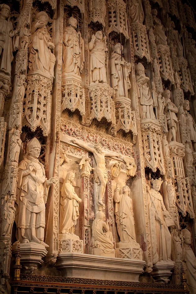 Sculptural details of a church, with stone carvings of religious figures.
