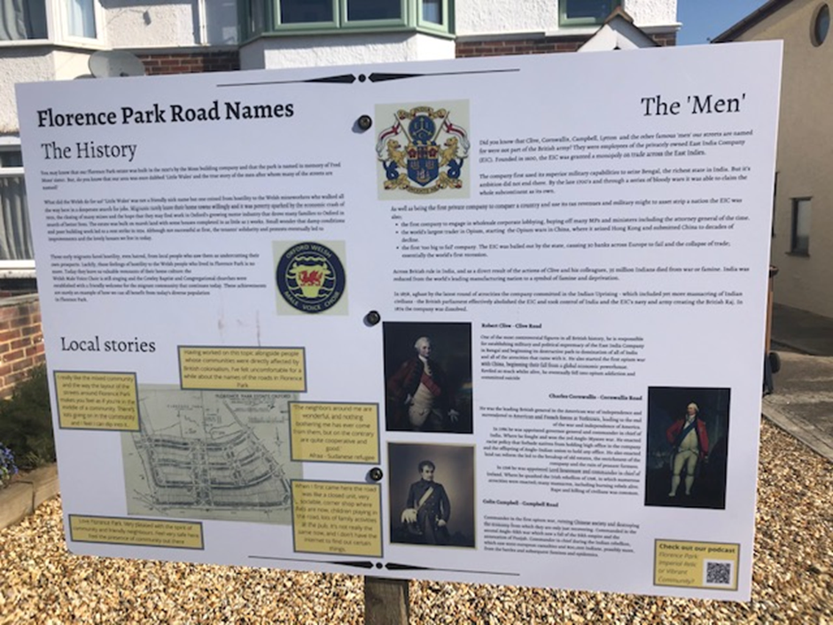 Information panel with text and images on a residential street. 