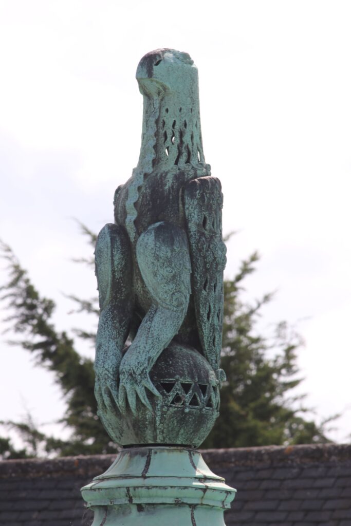A close up image of the bronze figure of the Zimbabwe bird which sits on tops of Rhodes House in Oxford.